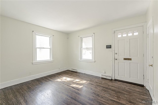 foyer entrance with plenty of natural light, dark wood finished floors, visible vents, and baseboards