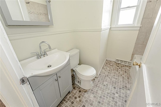 bathroom with toilet, tile patterned floors, and vanity