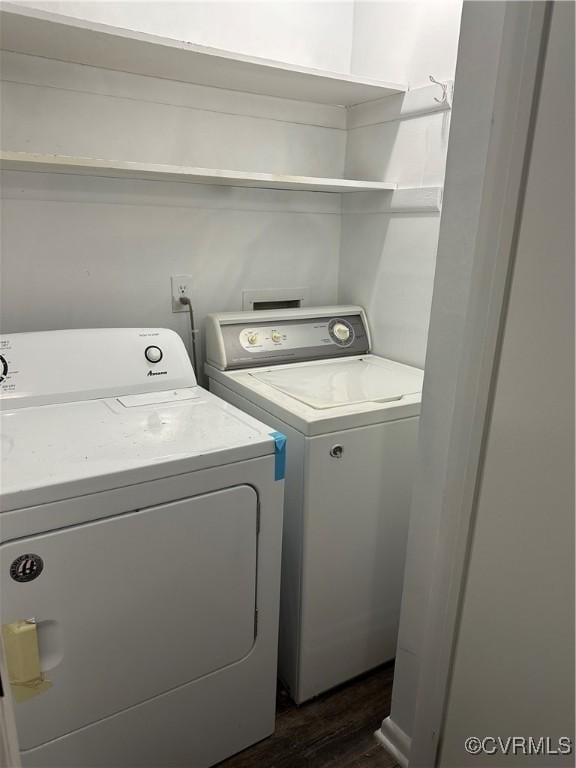 laundry area with washing machine and dryer, laundry area, and dark wood-style flooring