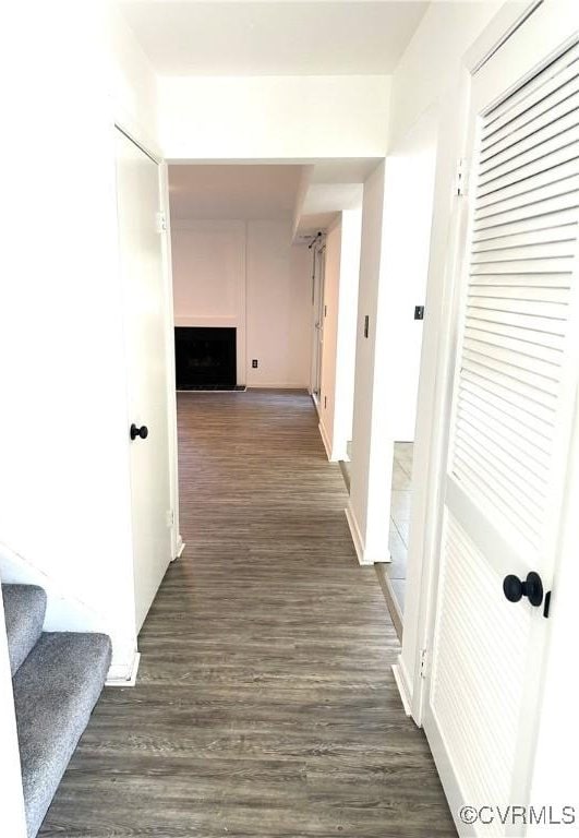 corridor with dark wood-style floors and stairs