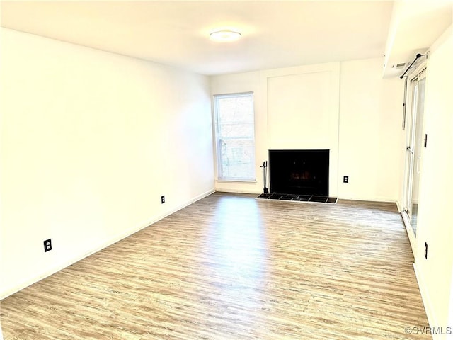 unfurnished living room featuring a fireplace and wood finished floors