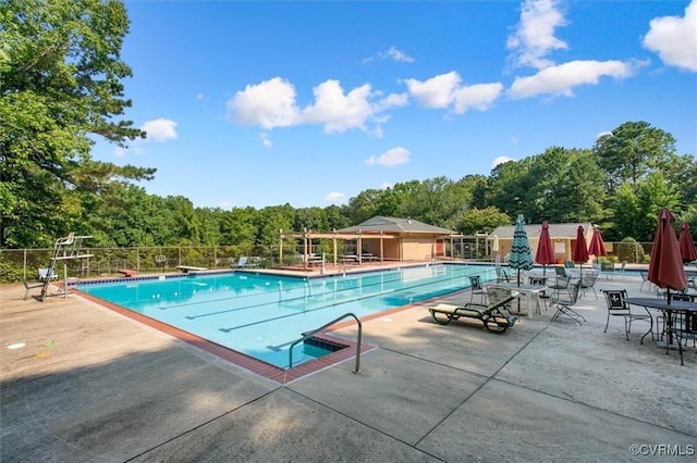 pool featuring a patio area and fence