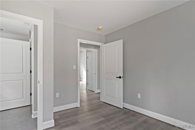 unfurnished bedroom featuring light wood-style flooring and baseboards