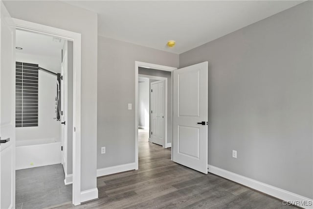 unfurnished bedroom with dark wood-style floors and baseboards