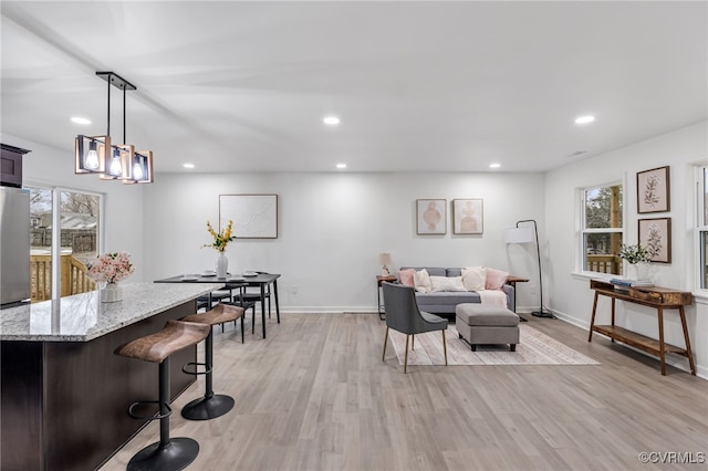 living room featuring recessed lighting, a healthy amount of sunlight, and light wood finished floors