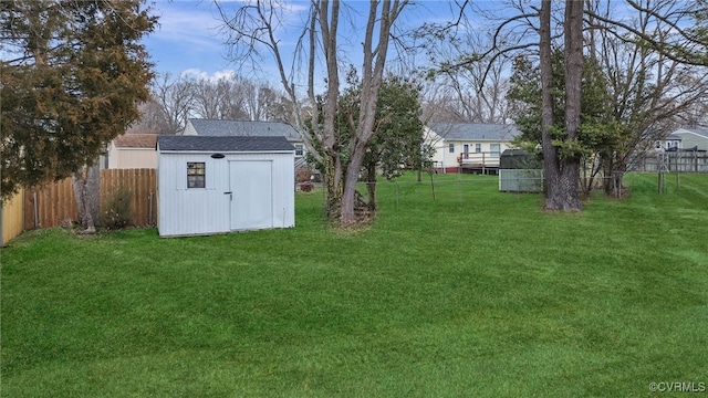 view of yard with a storage shed, an outdoor structure, and a fenced backyard