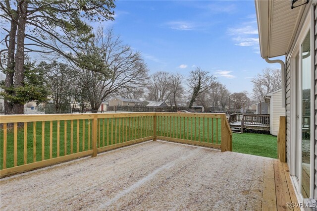 wooden terrace with a residential view, a fenced backyard, and a lawn