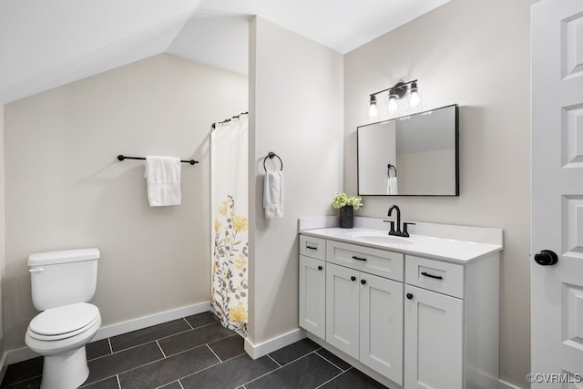 bathroom featuring baseboards, a shower with shower curtain, toilet, tile patterned floors, and vanity