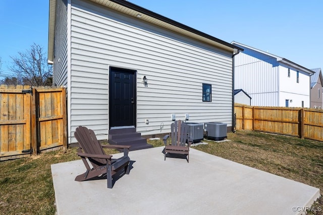 back of property featuring entry steps, a patio, central AC, and fence