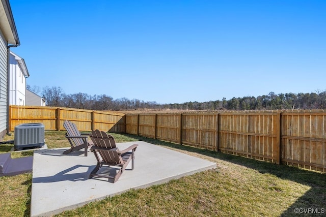 view of yard with a fenced backyard, a patio, and central air condition unit