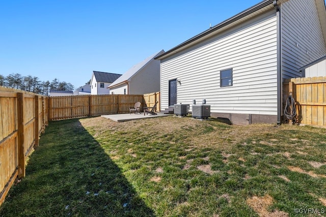 rear view of property featuring a fenced backyard, a yard, a patio, and central air condition unit