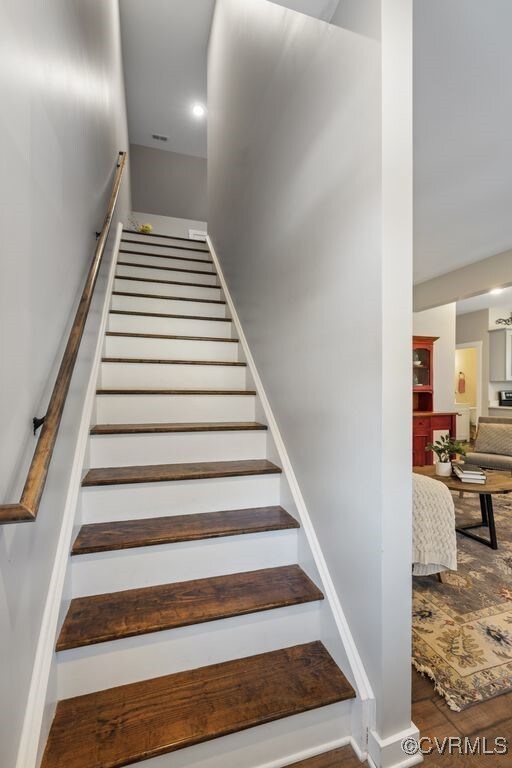 stairs with baseboards and wood finished floors