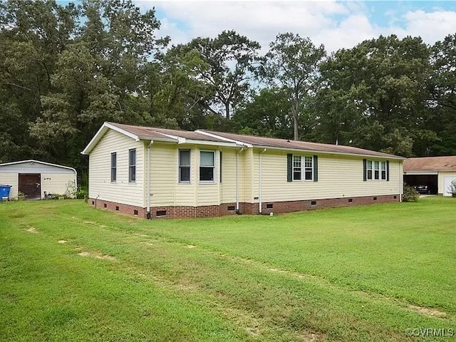 view of front of property with crawl space, a detached garage, and a front lawn