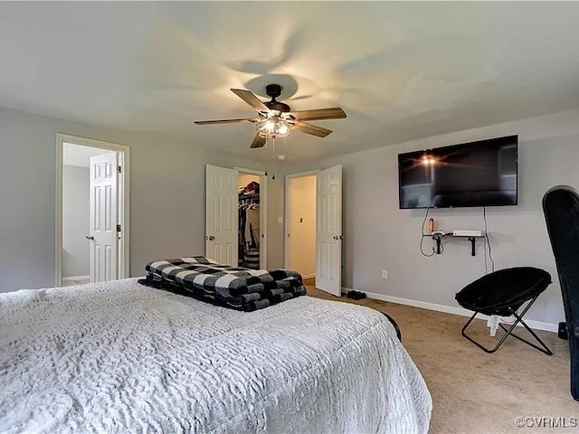 bedroom with ceiling fan, baseboards, and carpet