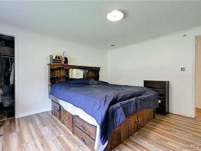 bedroom with baseboards and light wood finished floors