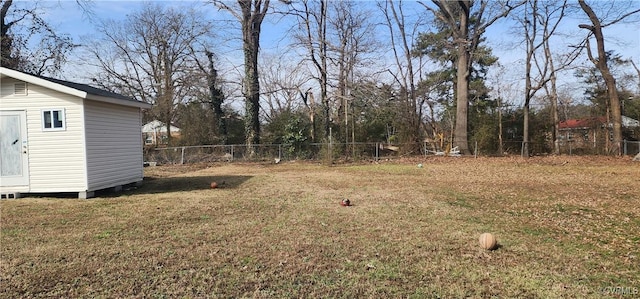 view of yard featuring a fenced backyard, a storage unit, and an outdoor structure