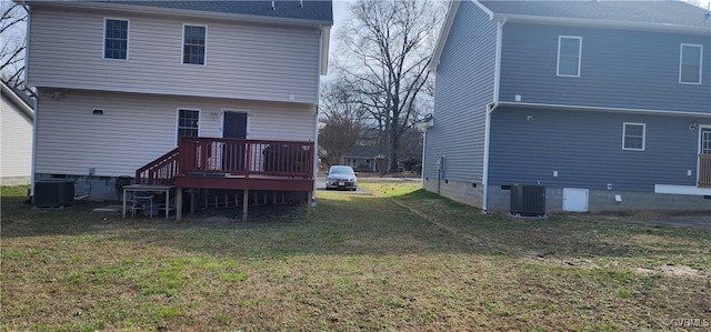 rear view of house featuring cooling unit, a yard, and a deck