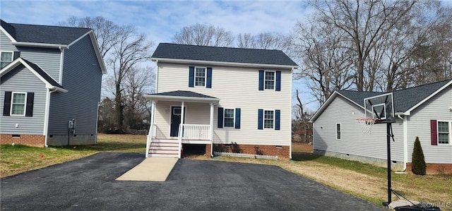 view of front of home with crawl space, driveway, a front lawn, and a porch