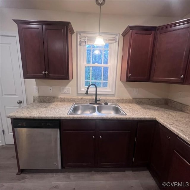 kitchen featuring decorative light fixtures, light countertops, stainless steel dishwasher, a sink, and dark brown cabinets