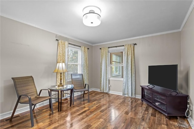 sitting room with baseboards, crown molding, visible vents, and wood finished floors