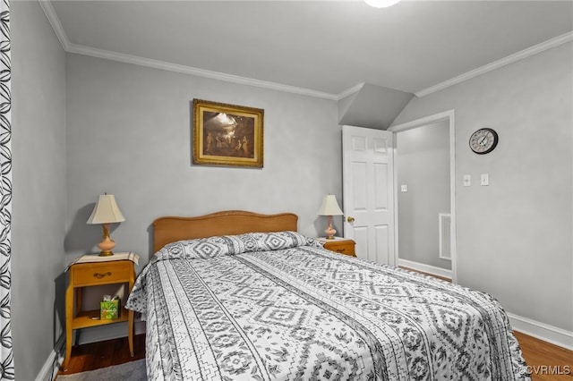 bedroom featuring ornamental molding, visible vents, baseboards, and wood finished floors