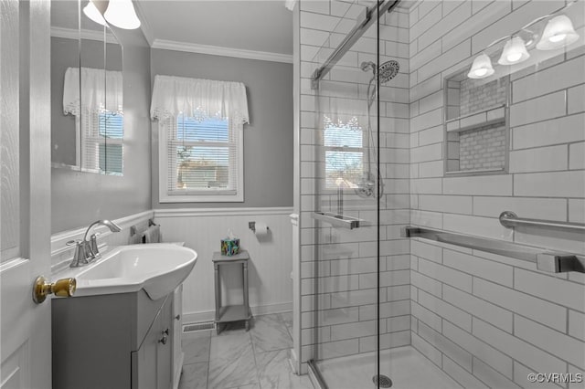 full bathroom featuring marble finish floor, a stall shower, wainscoting, and crown molding