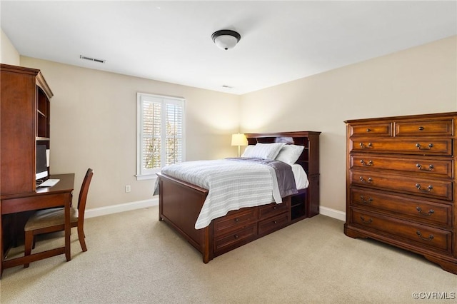 bedroom with baseboards, visible vents, and light carpet