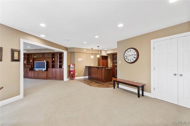 interior space with bar area, recessed lighting, light colored carpet, and baseboards