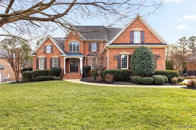 traditional-style house with brick siding and a front lawn