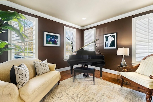 sitting room featuring crown molding, baseboards, and wood finished floors