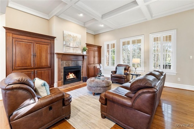 living area with light wood-style flooring, a fireplace, coffered ceiling, and baseboards