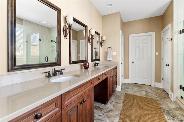 full bathroom with double vanity, a shower stall, and a sink