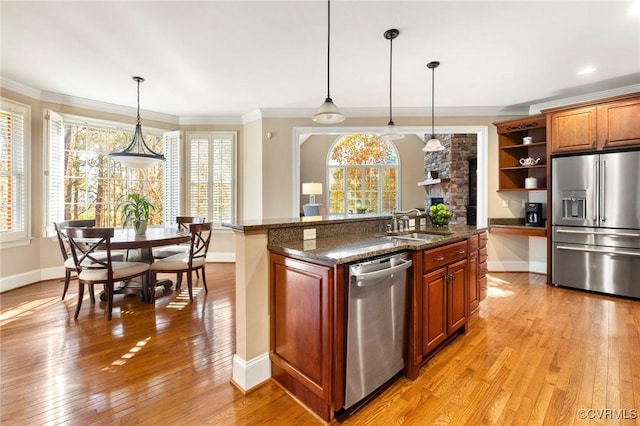 kitchen with open shelves, a sink, stainless steel appliances, crown molding, and light wood finished floors