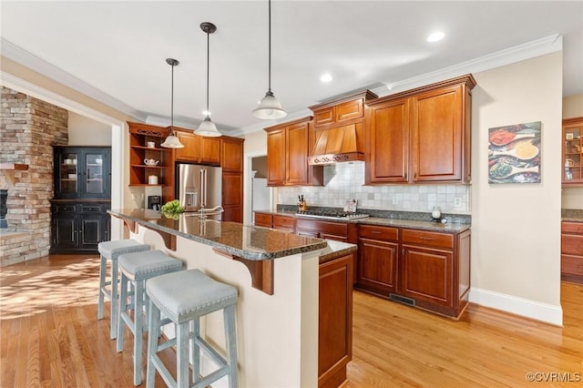 kitchen with a kitchen bar, light wood-type flooring, open shelves, backsplash, and appliances with stainless steel finishes