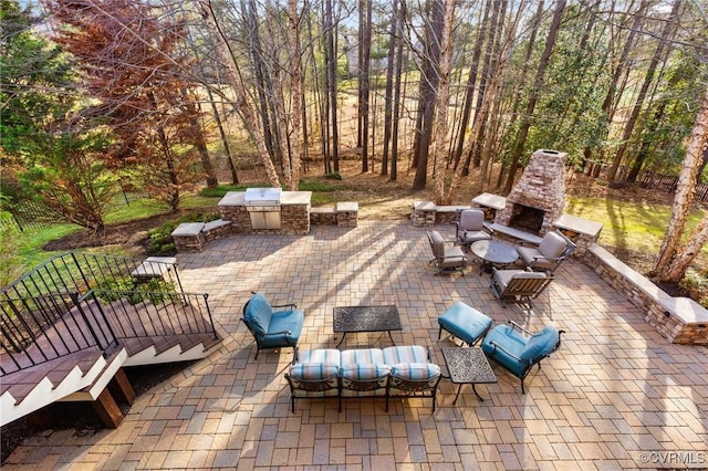 view of patio / terrace featuring an outdoor living space with a fireplace and an outdoor kitchen