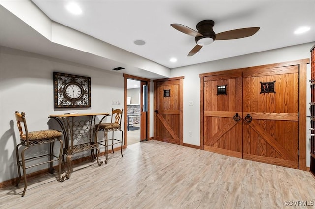 interior space featuring visible vents, baseboards, recessed lighting, wood finished floors, and a ceiling fan