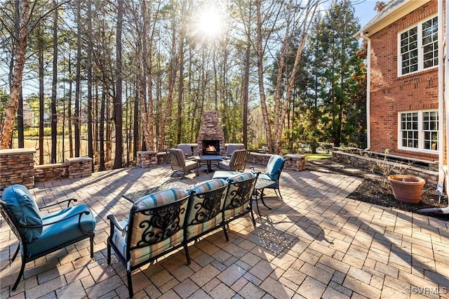 view of patio with an outdoor living space with a fireplace