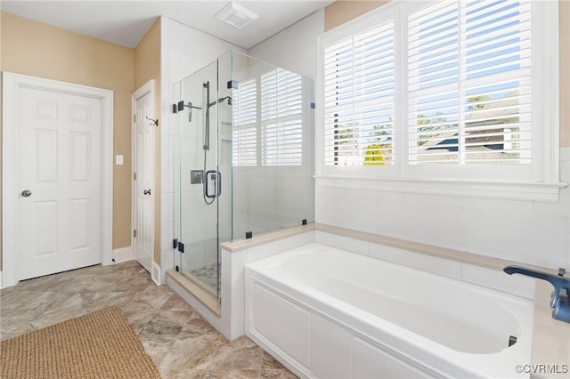 bathroom featuring a stall shower, visible vents, and a bath