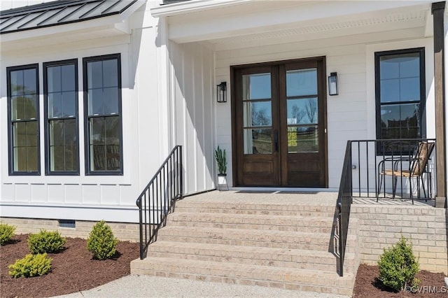 property entrance with metal roof, french doors, crawl space, board and batten siding, and a standing seam roof