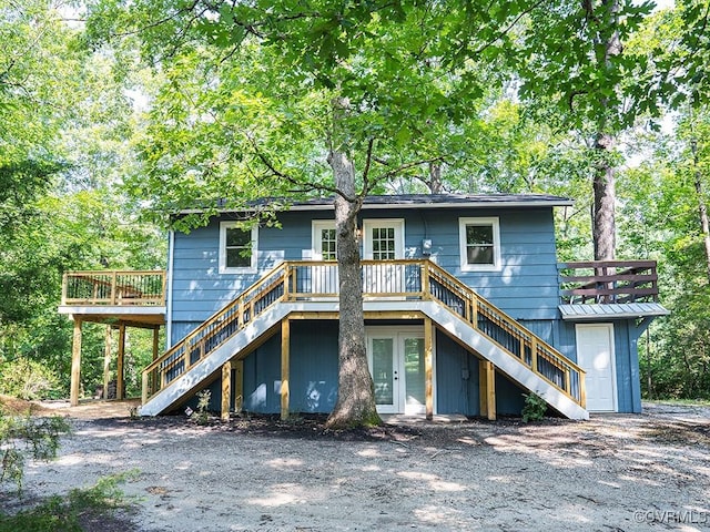 view of front of house with stairs and a deck