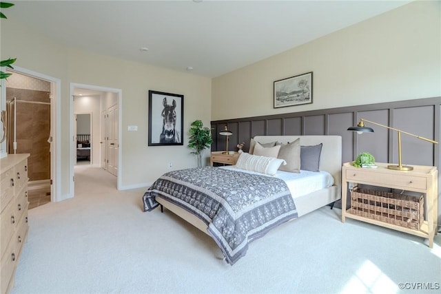 bedroom with light colored carpet and baseboards