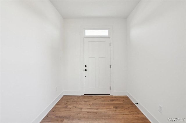 doorway to outside featuring light wood-style floors and baseboards