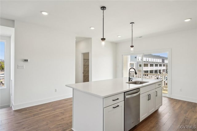 kitchen with a sink, dark wood-style floors, stainless steel dishwasher, and recessed lighting