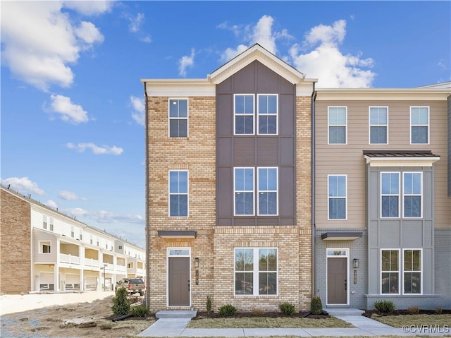 townhome / multi-family property with brick siding