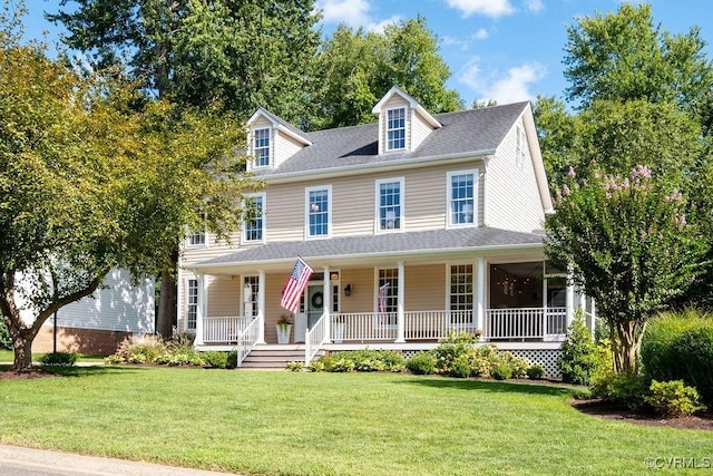 view of front facade featuring roof with shingles, a porch, and a front yard