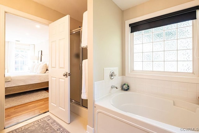 ensuite bathroom featuring a stall shower, tile patterned floors, a bath, and ensuite bathroom