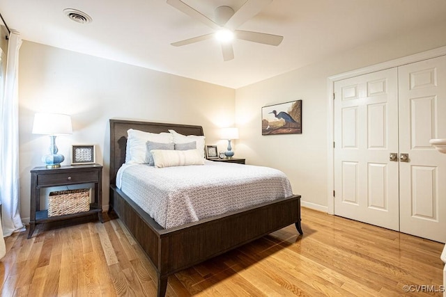 bedroom with visible vents, baseboards, a ceiling fan, light wood-style flooring, and a closet