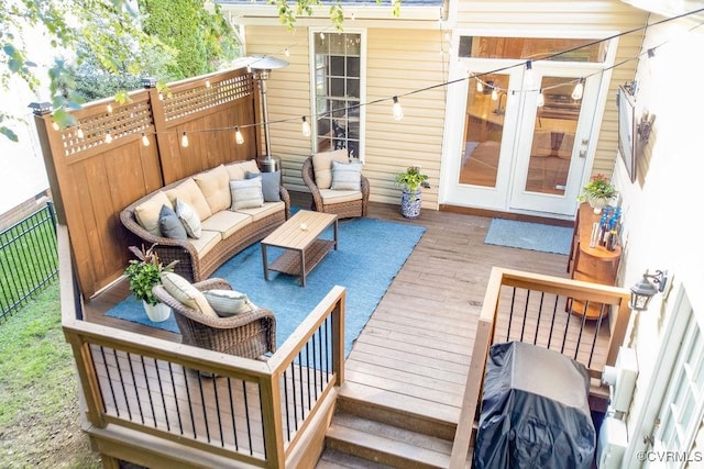 wooden deck with fence and an outdoor living space