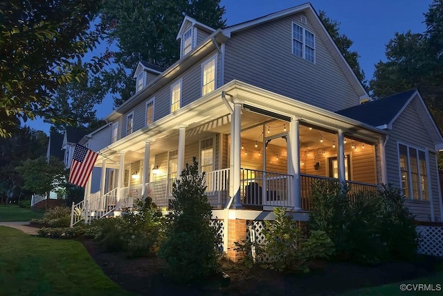 view of side of home with covered porch