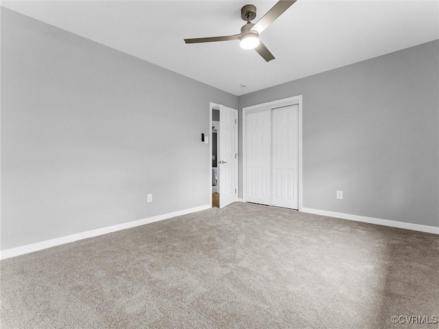 unfurnished bedroom featuring a ceiling fan, carpet, a closet, and baseboards